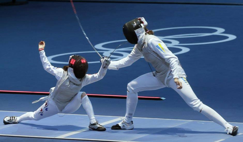 Hyun Hee Nam of South Korea, left, and Olga Leleyko of Ukraine compete in the round of 32 during women's fencing at the 2012 Summer Olympics.