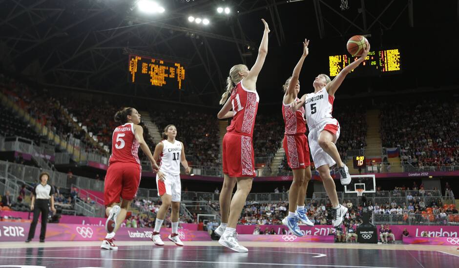 Canada's Teresa Gabriele (5) shoots over Russia's Kim Smith (8) and Natalie Achonwa (11) during the second half of a preliminary women's basketball game at the 2012 Summer Olympics.