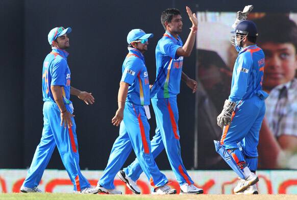 Rahul Sharma celebrates the dismissal of Sri Lanka's batsman Mahela Jayawardene during the third one-day international cricket match between India and Sri Lanka in Colombo.