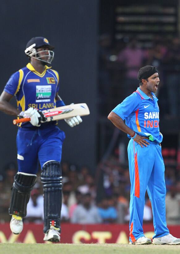 Ashok Dinda reacts to a miss-field as Sri Lanka's batsman Angelo Mathews runs between the wickets during the third one-day international cricket match between India and Sri Lanka in Colombo.