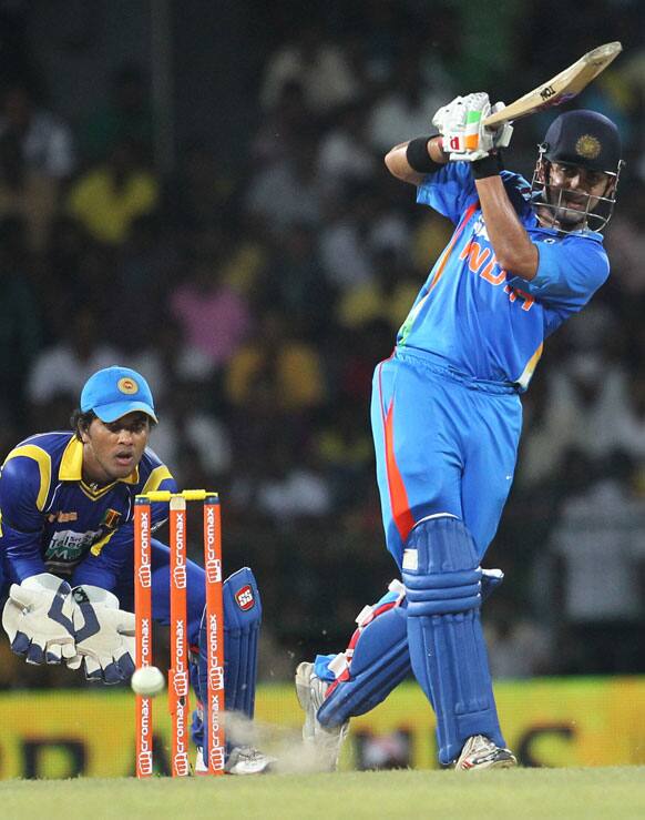 Gautam Gambhir, bats as Sri Lanka's wicket keeper Dinesh Chandimal, left watches during the third one-day international cricket match between India and Sri Lanka in Colombo.