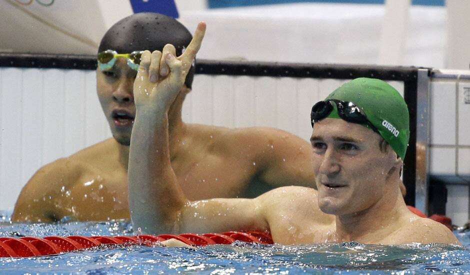 South Africa's Cameron van der Burgh waves as Japan's Kosuke Kitajima looks on after their men's 100 meters breaststroke semifinal at the Aquatics Centre in the Olympic Park during the 2012 Summer Olympics in London.