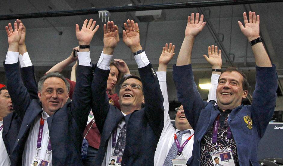 Russian Prime Minister Dmitry Medvedev, right, Deputy Prime Minister and Russia's Olympic Committee president Alexander Zhukov, center, and Sports Minister Vitaly Mutko, left, react during a women's preliminary volleyball match between Britain and Russia at the 2012 Summer Olympics, in London.