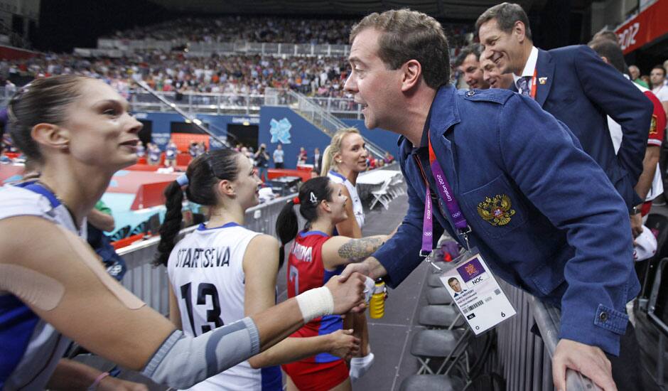 Russian Prime Minister Dmitry Medvedev, right, congratulates a member of the Russian volleyball team Yekaterina Gamova after a women's preliminary volleyball match between Britain and Russia at the 2012 Summer Olympics, in London.