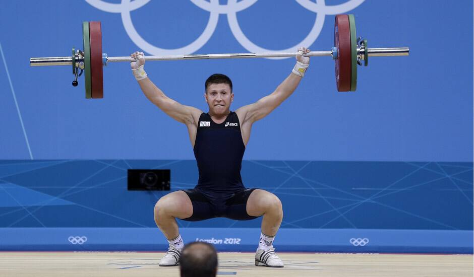 Italy's Mirco Scarantino lifts during the men's 56-kg, group B, weightlifting competition at the 2012 Summer Olympics in London.