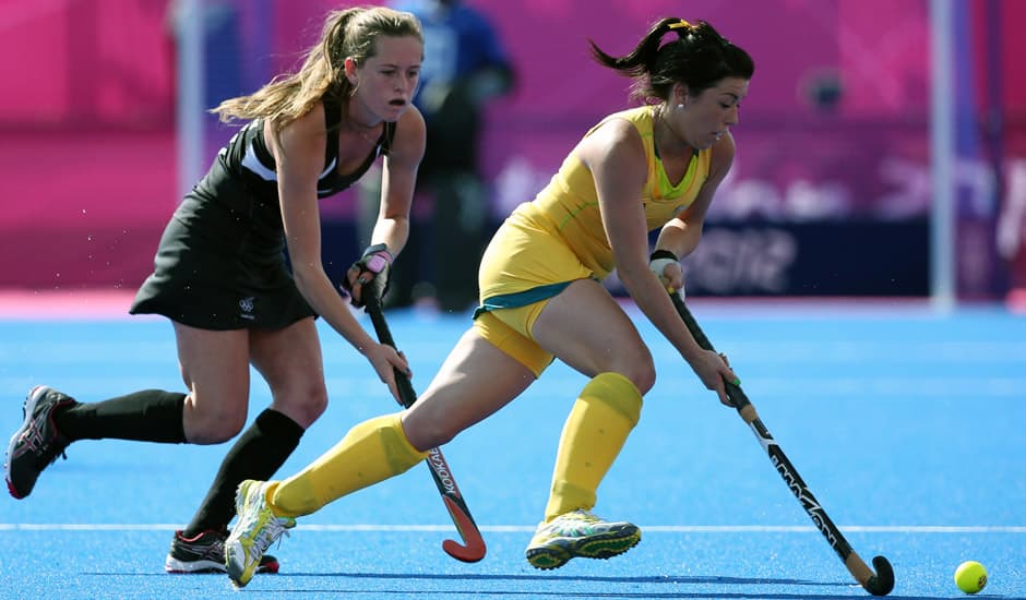 Australia's Anna Flanagan, right, and New Zealand's Samantha Harrison, vie for the ball during their preliminary round women's field hockey match at the 2012 Summer Olympics in London. 