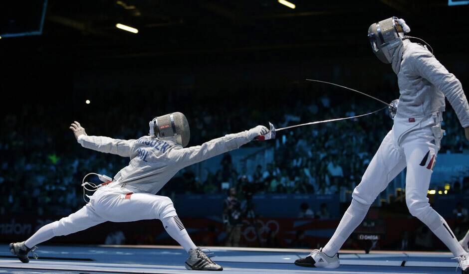 Germany's Nicolas Limbach, right, and Poland's Adam Skrodzki compete during the men's individual sabre round of 32 fencing at the 2012 Summer Olympics in London. 