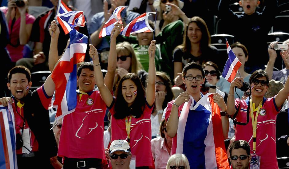 Fans cheer as Nina Lamsan Ligon, of Thailand, and her horse Butts Leon, compete in the equestrian eventing dressage phase at the 2012 Summer Olympics in London. 