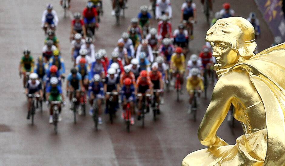 The peloton passes by the Queen Victoria Memorial near Buckingham Palace during the women's road cycling race at the 2012 Summer Olympics in London. 