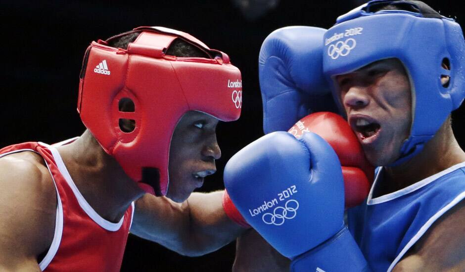 Wellington Arias Romero of the Dominican Republic lands a punch against Colombia's Eduar Marriaga Campo during men's light 60-kg boxing at the 2012 Summer Olympics in London.