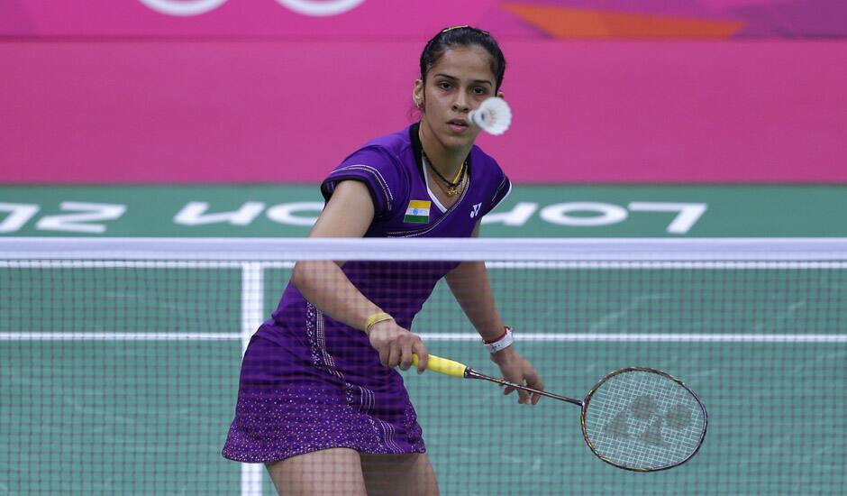 Saina Nehwal plays against Switzerland's Sabrina Jaquet, unseen, at a women's singles badminton match of the 2012 Summer Olympics in London.