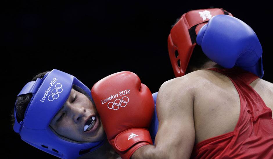 Kazakhstan's Danabek Suzhanov fights India's Vijender, right, during a middle weight 75-kg preliminary boxing match at the 2012 Summer Olympics.