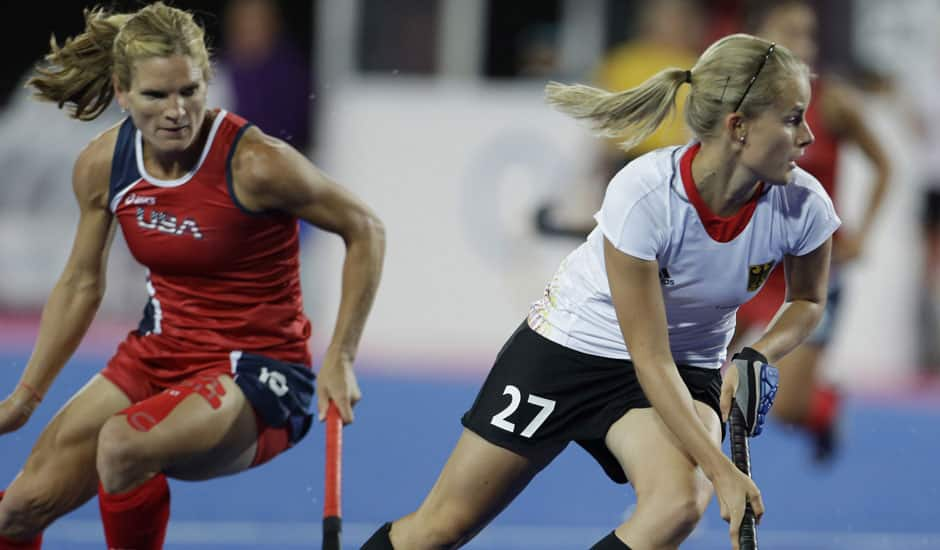 Germany's Anke Brockmann (27) steals the ball from the United States' Katie O'Donnell (16) during the women's hockey preliminary match at the 2012 Summer Olympics.