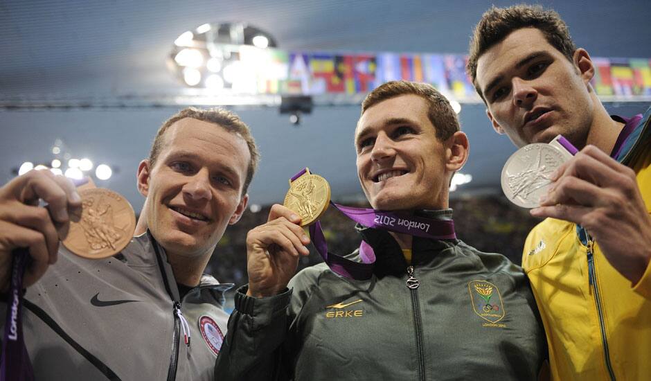 United States' Brendan Hansen, left, South Africa's Cameron van der Burgh, center, and Australia's Christian Sprenger pose with their medals for the men's 100-meter breaststroke swimming final at the Aquatics Centre in the Olympic Park during the 2012 Summer Olympics.