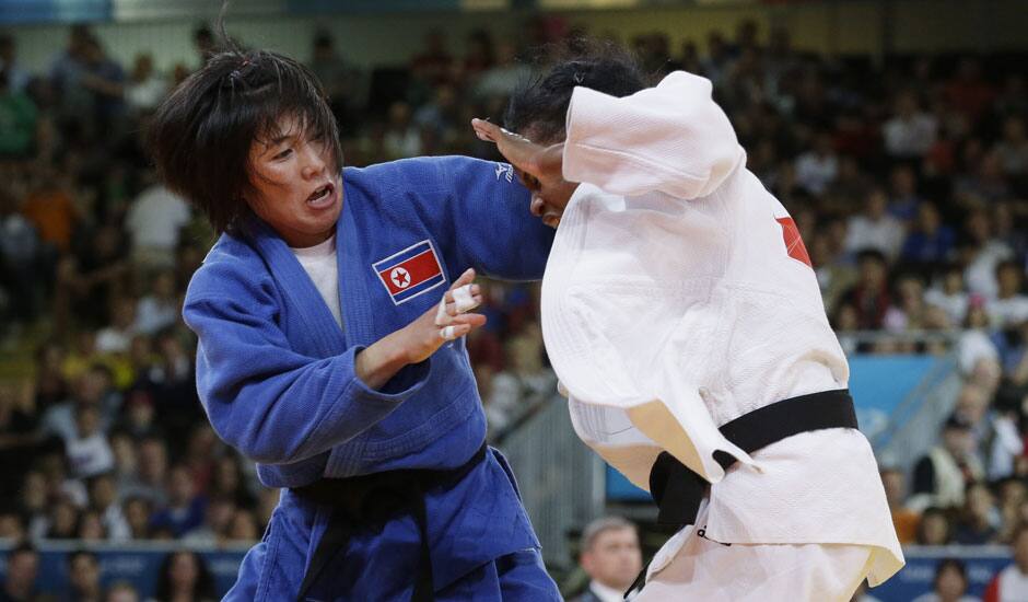 North Korea's An Kum Ae, left, competes with Cuba's Acosta Bermoy during the gold medal match in the women's 52-kg judo competition at the 2012 Summer Olympics.