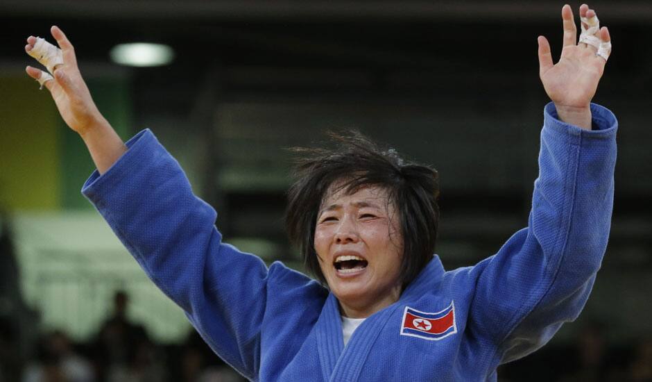 North Korea's An Kum Ae celebrates after defeating Cuba's Acosta Bermoy in the gold medal match in the women's 52-kg judo competition at the 2012 Summer Olympics.