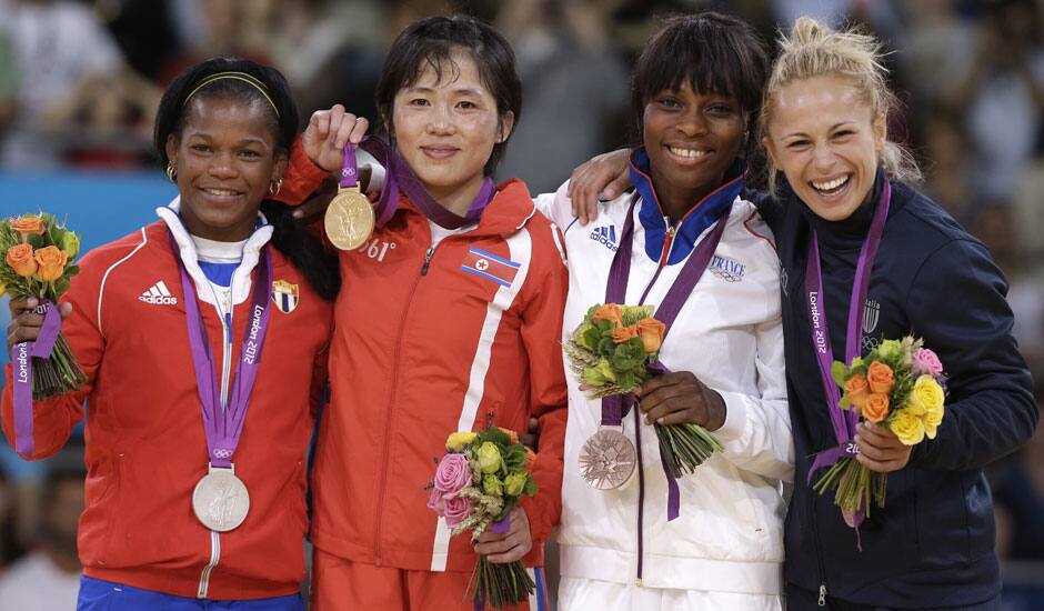 Silver medalist Acosta Bermoy, of Cuba, from left, gold medalist An Kum Ae, of North Korea and bronze medalists Priscilla Gneto, of France and Rosalba Forciniti, of Italy, share the podium after the women's 52-kg judo competition at the 2012 Summer Olympics.