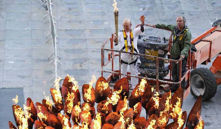 Torchbearer Austin Playfoot, top center, poses after lighting the Olympic cauldron at the Olympic Stadium during the 2012 Summer Olympics.