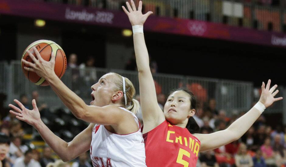 Croatia's Andja Jelavic, left, drives to the basket against Song Xiaoyun during a women's basketball game at the 2012 Summer Olympics.