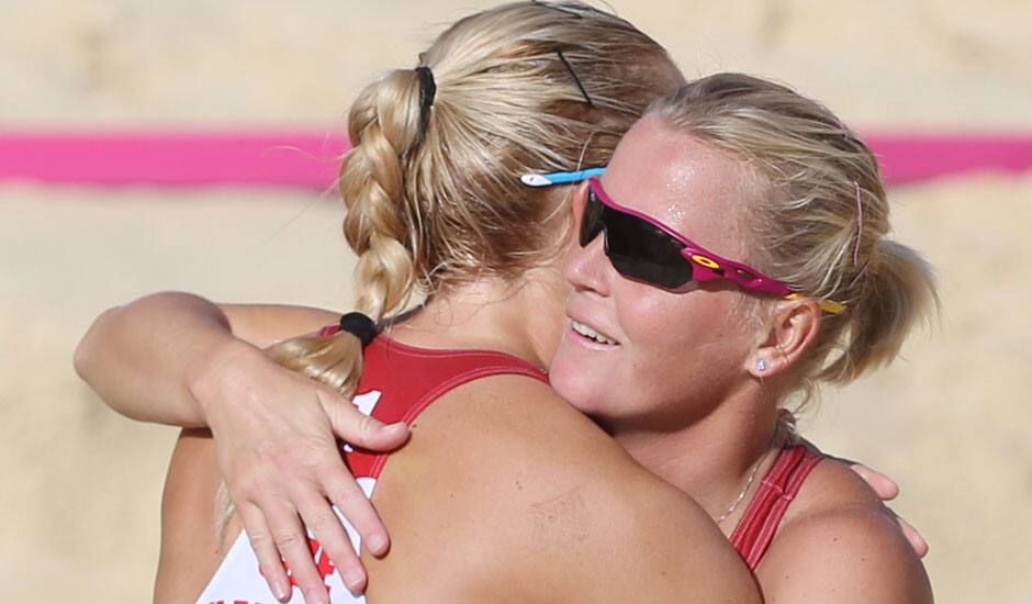 Lenka Hajeckova, right, from Czech Republic celebrates with her teammate Hana Klapalova, left, after defeating Mauritius in their Beach Volleyball match at the 2012 Summer Olympics.