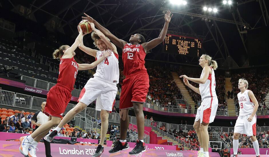 Czech Republic's Jana Vesela (4) is defended by Czech Republic's Katerina Bartonova (6) and Republic's Lenka Bartakova (12) during the first half of a preliminary women's basketball game at the 2012 Summer Olympics in London. 