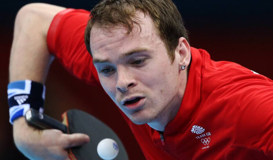 Paul Drinkhall of Great Britain serves against Dimitrij Ovtcharov of Germany during their men's table tennis match at the 2012 Summer Olympics in London. 