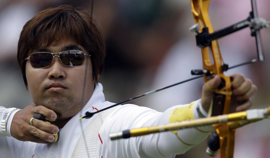 South Korea's Im Dung-hyun shoots during an elimination round of the individual archery competition at the 2012 Summer Olympics in London. 