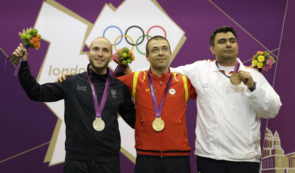 Gold medalist Alin George Moldoveanu of Romania poses with silver medalist Italy's Niccolo Campriani and bronze medalist India's Gagan Narang, during the victory ceremony for the men's 10-meter air rifle at the 2012 Summer Olympics in London.