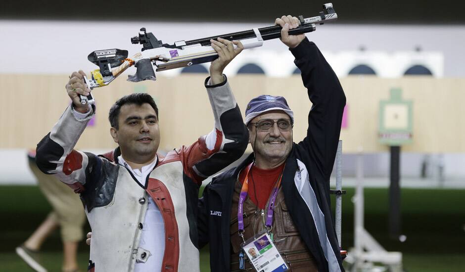 Gagan Narang,  celebrates winning the bronze medal in the men's 10-meter air rifle, with his coach Stanislav Lapidus, at the 2012 Summer Olympics in London. 