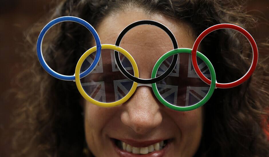 Dana Kerstein wears glasses with the Olympic rings as she attends the archery competition at the 2012 Summer Olympics in London.