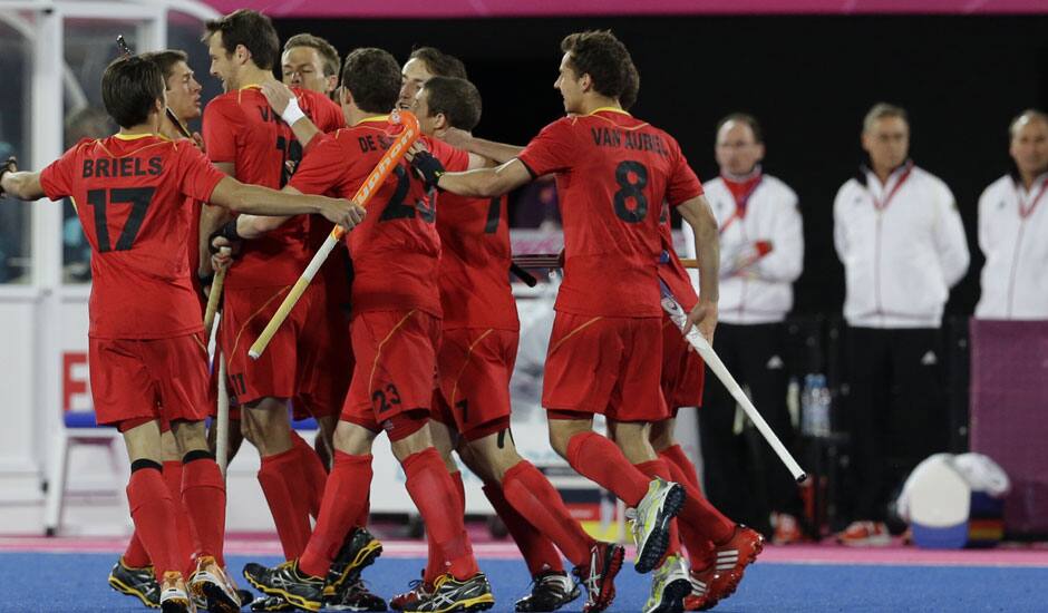 Belgian players celebrate their goal against Germany during their men's hockey preliminary match at the 2012 Summer Olympics.