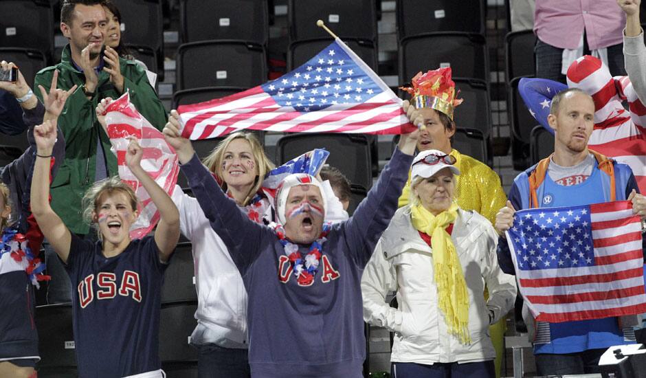 Fans cheer for the United States during a beach volleyball match against the Czech Republic at the 2012 Summer Olympics.