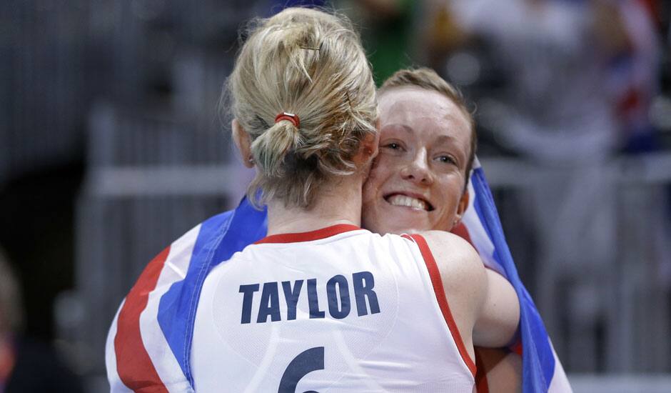 Britain's Jennifer Taylor (6) and teammate Lynne Beattie hug after their team defeated Algeria in a women's preliminary volleyball match at the 2012 Summer Olympics.