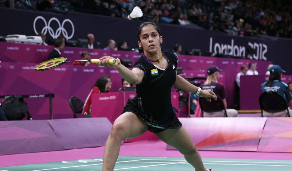 India's Saina Nehwal plays against Belgium's Lianne Tan, unseen, at a woman's singles badminton match of the 2012 Summer Olympics.