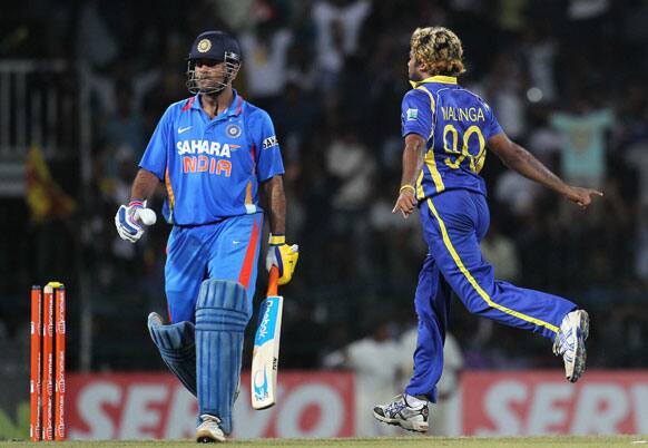 Sri Lankan bower Lasith Malinga, right celebrates the dismissal of India's captain Mahendra Singh Dhoni, left during the third one-day international cricket match between India and Sri Lanka in Colombo.