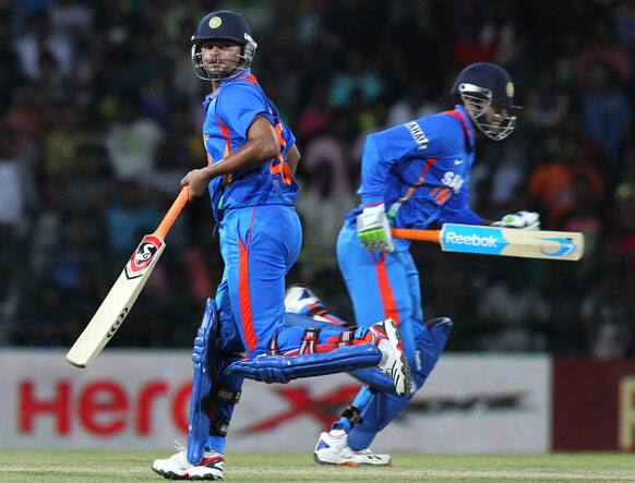 Suresh Raina, left and Irfan Pathan, right run between the wickets during the third one-day international cricket match between India and Sri Lanka in Colombo.