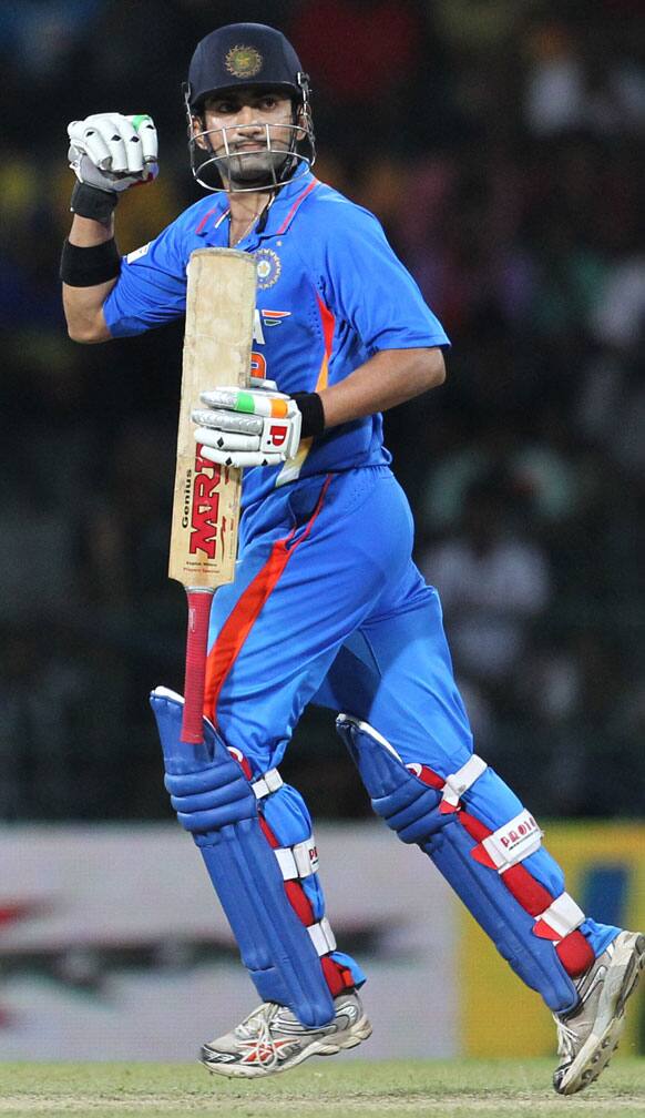 Gautam Gambhir celebrates as he tuns to complete his century during the third one-day international cricket match between India and Sri Lanka in Colombo.