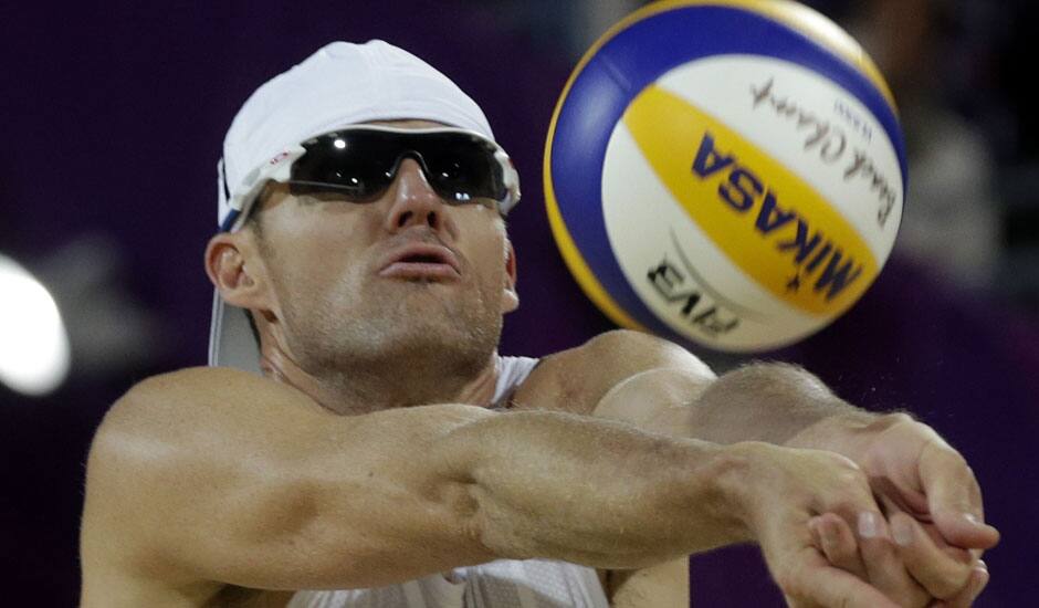 Jacob Gibb of the United States sets the ball during a loss to Poland during a beach volleyball match at the 2012 Summer Olympics in London. 