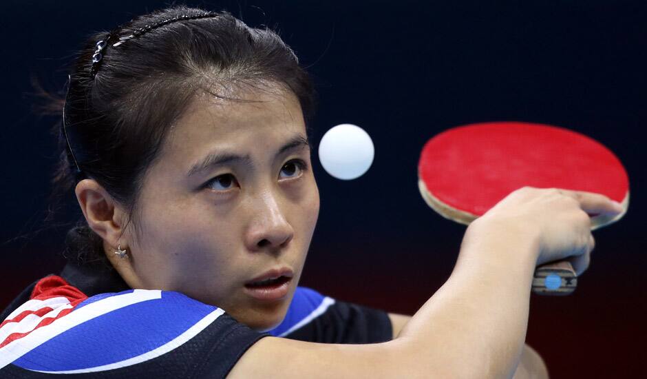 Kim Kyungah of South Korea competes against Tianwei Feng of Singapore during the women's singles table tennis competition at the 2012 Summer Olympics in London.