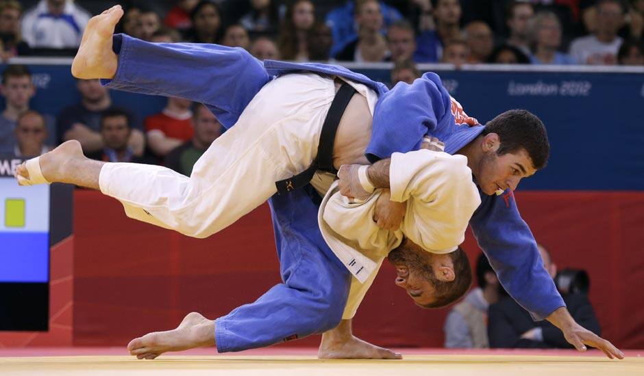 Travis Stevens of the United States competes with Avtandil Tchrikishvili of Georgia, top, during the men's 81-kg judo competition at the 2012 Summer Olympics.