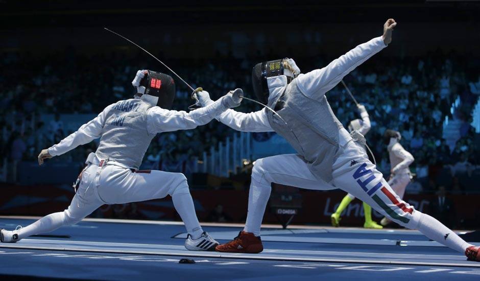 Radu Daraban of Romania, left, and Valerio Aspromonte of Italy compete during his men's individual foil fencing match against Mohamed Samandi of Tunisia at the 2012 Summer Olympics.