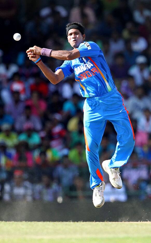 Ashok Dinda leaps in the air to hold a ball during the fourth one-day international cricket match between India and Sri Lanka in Colombo.