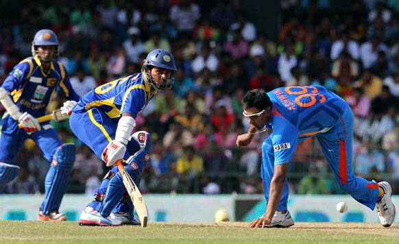 Ravichandran Ashwin, right reaches to hold the ball as Sri Lanka's batsmen Lahiru Thirimanne, center and Dinesh Chandimal, left run between the wickets during the fourth one-day international cricket match between India and Sri Lanka in Colombo.