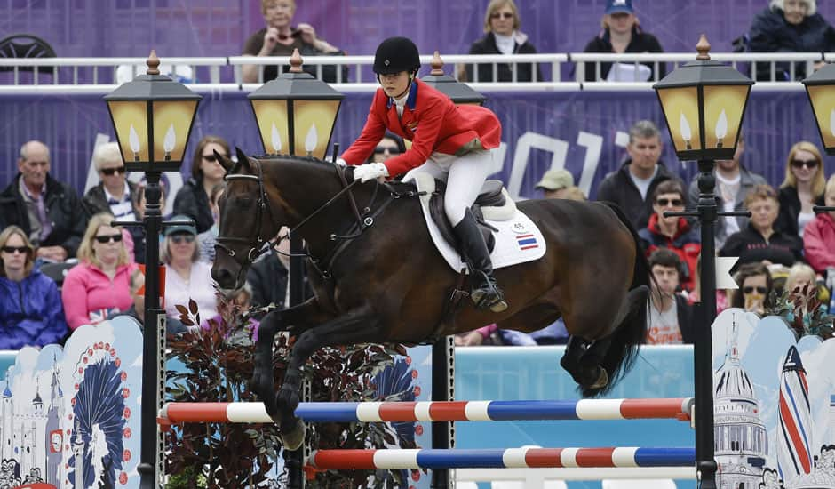 Nina Lamsam Ligon of Thailand rides her horse Butts Leon in the show-jumping phase of the equestrian eventing competition at the 2012 Summer Olympics, at Greenwich Park in London.