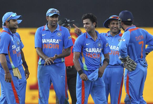 Manoj Tiwary, third right, celebrates the dismissal of Sri Lanka's batsman Thisara Perera, unseen, with Virat Kohli, left, Ravichandran Ashwin, second left, and Virender Sehwag, second right, during the fourth one-day international cricket match against Sri Lanka in Colombo.