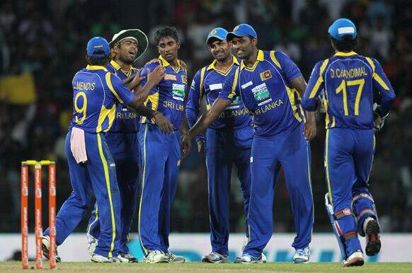 Sri Lanka's bowler Nuwan Pradeep, celebrates the dismissal of Rohit Sharma, unseen with teammates from left, Jeevan Mendis, Lasith Malinga, Lahiru Thirimanne, and Thisara Perera, during the fourth one-day international cricket match between India and Sri Lanka in Colombo.