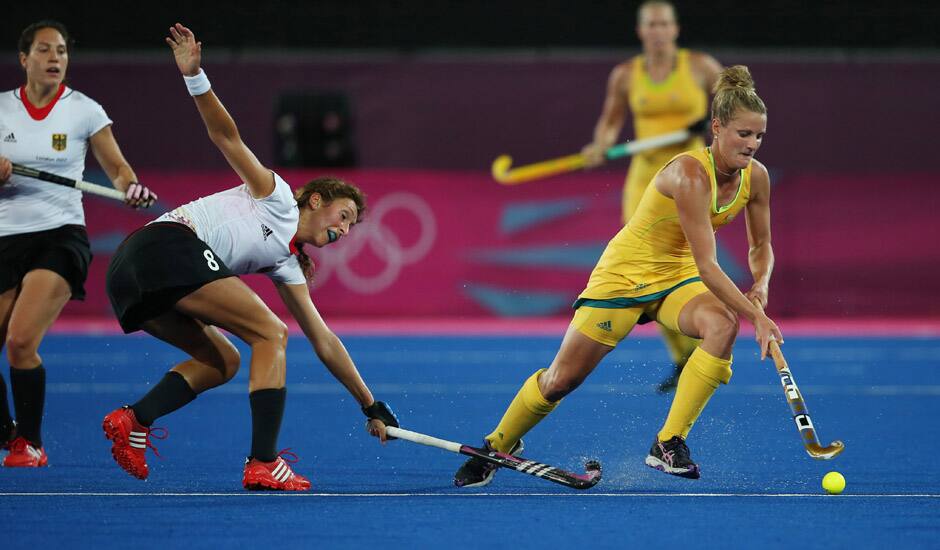 Australia's Kobie McGurk, right, and Germany's Christina Schuetze vie for the ball during their women's hockey preliminary round match at the 2012 Summer Olympics in London.