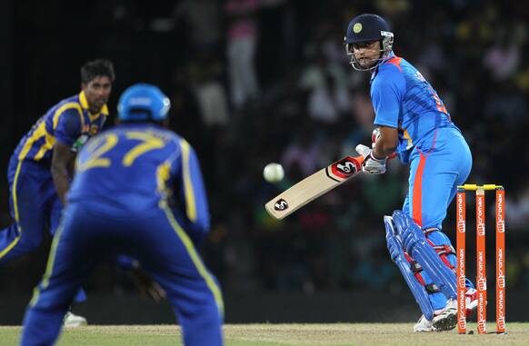 Suresh Raina, right, looks back after edging a ball to Sri Lankan captain Mahela Jayawardene, second left, during the fourth one-day international cricket match between India and Sri Lanka in Colombo.