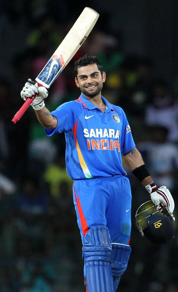 Virat Kohli celebrates after scoring a century during the fourth one-day international cricket match between India and Sri Lanka in Colombo.