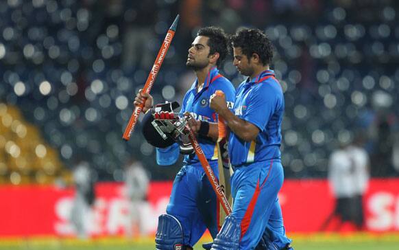 Virat Kohli and Suresh Raina walk back to the pavilion as India beat Sri Lanka by six-wickets to take an unbeatable 3-1 lead in 5 match ODI series during the fourth one-day international cricket match between India and Sri Lanka in Colombo.